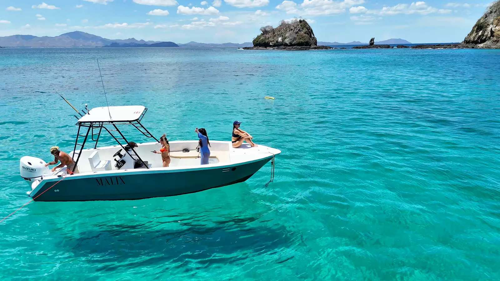 The Malix 24-foot boat anchored in turquoise water